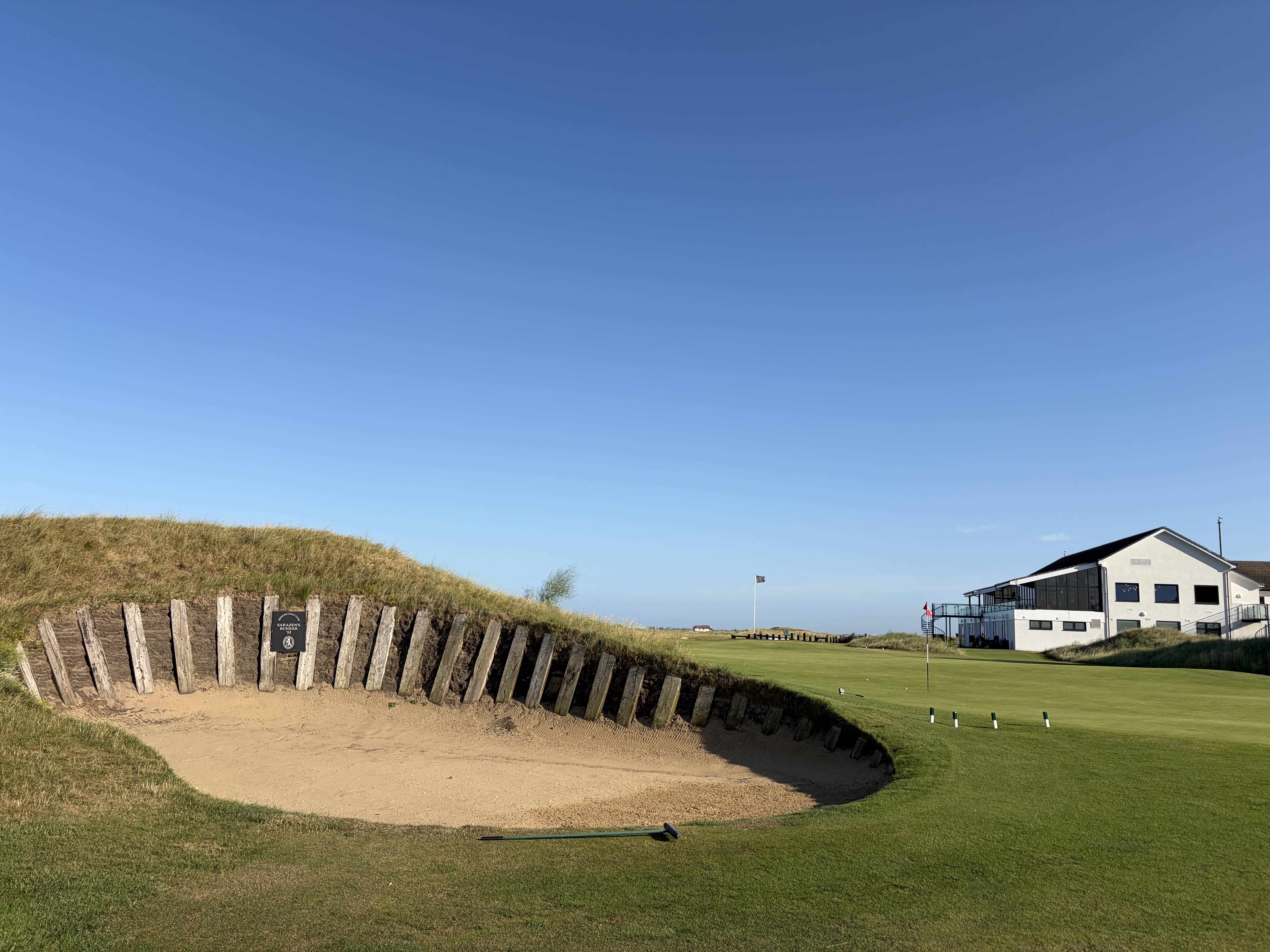 One of Prince's deep, sleeper-walled bunkers, with the clubhouse behind